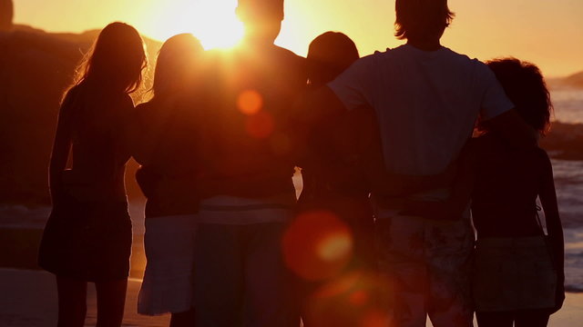 Silhouettes of friends looking at the sunset