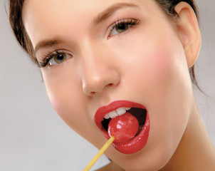 Lovely young woman with lolipop, on white background.