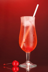 Cherry cocktail with ice on dark red background