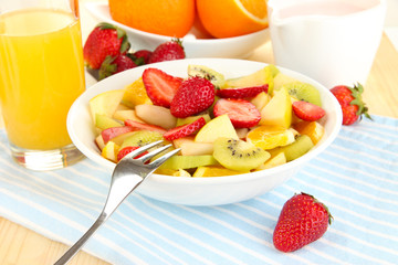 Useful fruit salad of fresh fruits and berries in bowl