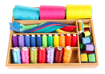 Sewing accessories in wooden box isolated on white