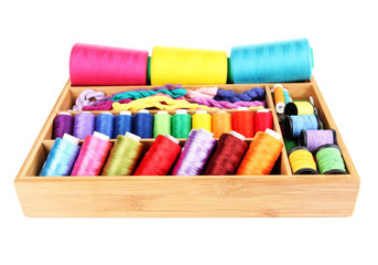 Colorful threads for needlework in wooden box isolated on white