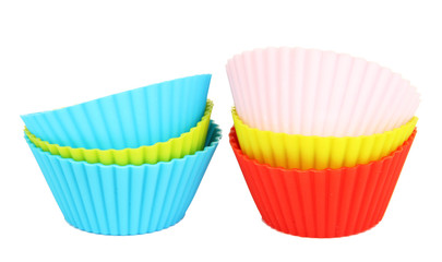 Stack of colorful cupcake cases isolated on white