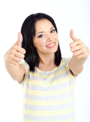 Happy young woman showing thumbs up sign isolated on white