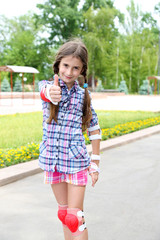 Little girl in roller skates at  park