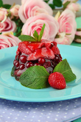 Tasty jelly dessert with fresh berries, on bright background