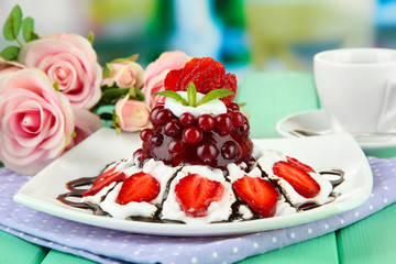 Tasty jelly dessert with fresh berries, on bright background