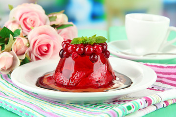 Tasty jelly dessert with fresh berries, on bright background