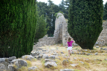 Naklejka na ściany i meble A girl sightseeing historical ruins of Asclepieion