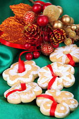 Obraz premium Christmas cookies and decorations on color fabric background