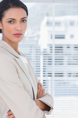 Brunette businesswoman with arms crossed