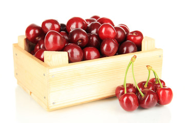Cherry berries in wooden box isolated on white