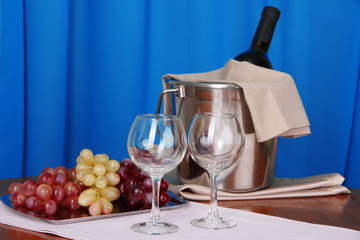 Wine and glasses on round table on cloth background