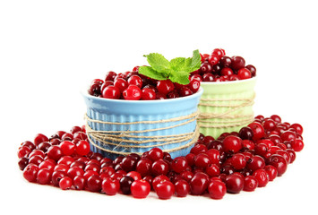 Ripe red cranberries in bowls, isolated on white.