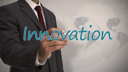 Businessman writing the word innovation