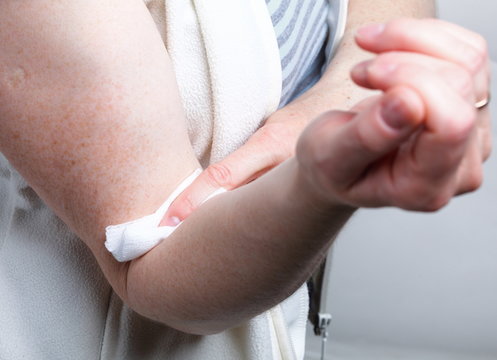 appying a swab to an arm after blood sample