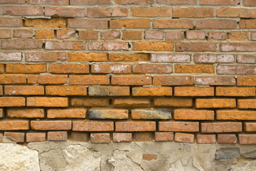 Broken red brick wall in rural