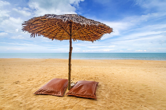 Tropical beach scenery with parasol and beds in Thailand