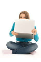 Naklejka premium beautiful woman hiding behind a laptop