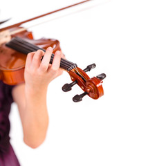 Young girl practicing the violin. Over white background.