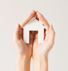 woman hands with paper house