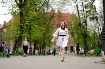 Fototapeta na wymiar Happy girl running in the park