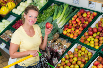 hausfrau kauft äpfel im supermarkt