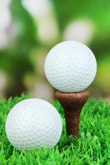 Golf balls on grass outdoor close up