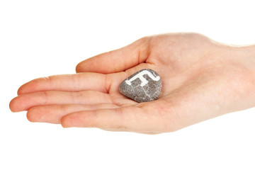 Fortune telling  with symbols on stone in hand isolated on