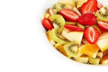Useful fruit salad of fresh fruits and berries in bowl isolated