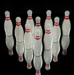 Ten bowling pins isolated on black background