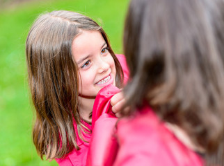 happy pretty little girl playing with her mother
