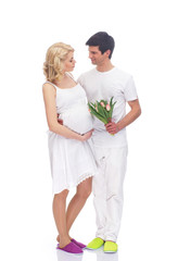 Young attractive couple: pregnant mother and happy father isolat