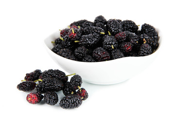 Ripe mulberries in bowl isolated on white