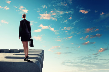 Businesswoman on top of building