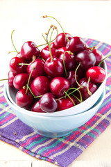 Fresh red summer cherries in bowl on the table