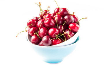 Fresh summer cherries in bowl on white