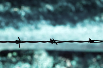 Barbed wire against a blue background