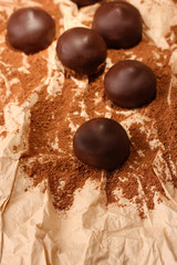 Chocolate candies with cocoa powder, close up
