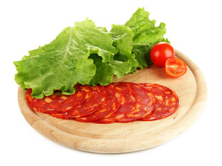 Salami slices on wooden board, isolated on white