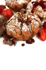 Fototapeta na wymiar Tasty muffin cakes with strawberries and chocolate, isolated