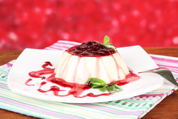 Panna Cotta with raspberry sauce, on bright background