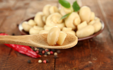 Fototapeta na wymiar Mushrooms on plate, on wooden background