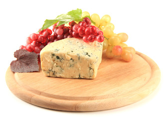 Tasty blue cheese and grape on cutting board, isolated on white