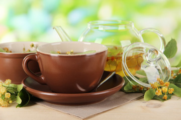 Kettle and cup of tea with linden