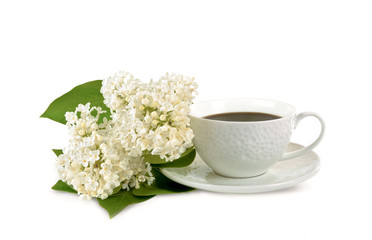 Mug of coffee and white flowers