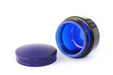 Empty glass can for cream isolated on white background