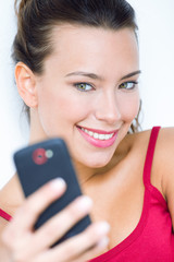 Cute brunette woman taking photo of herself