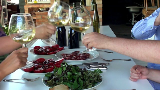 Clinking of a wine glasses in a country cottage