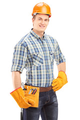 Confident and smiling manual worker with helmet looking at camer